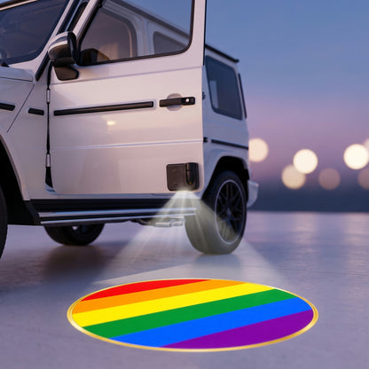 PRIDEMARK projecting the rainbow flag onto the ground under an open car door